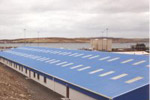 Translucent roof sheeting, lots of windows, personnel doors. Typical of this type of factory building
