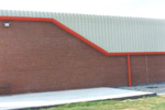 Factory Unit with red trims and curved eaves