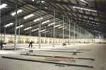 Inside of the factory building showing the row of props and roof lights